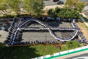 M.C. Dean employees form the sine wave during an employee engagement event.